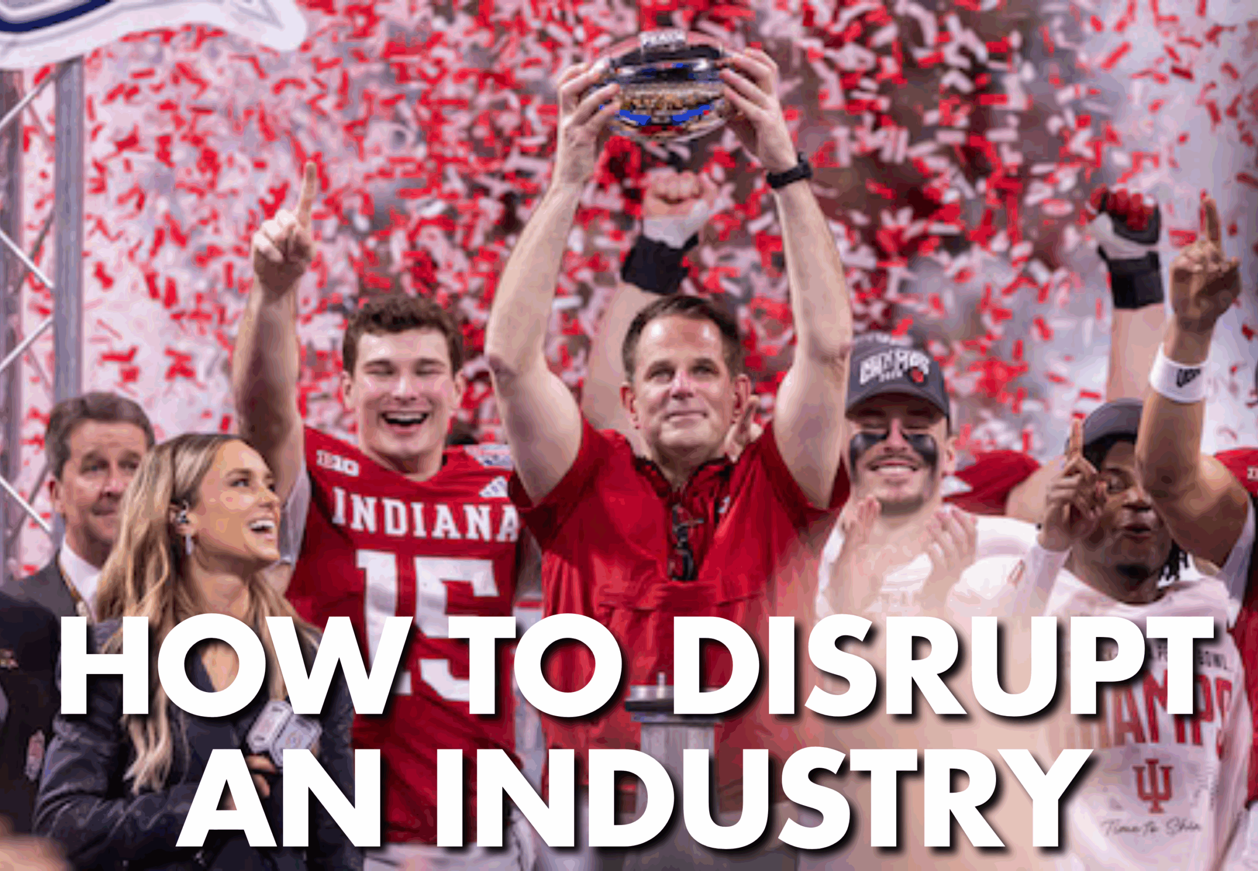 Football coach holding up a trophy.